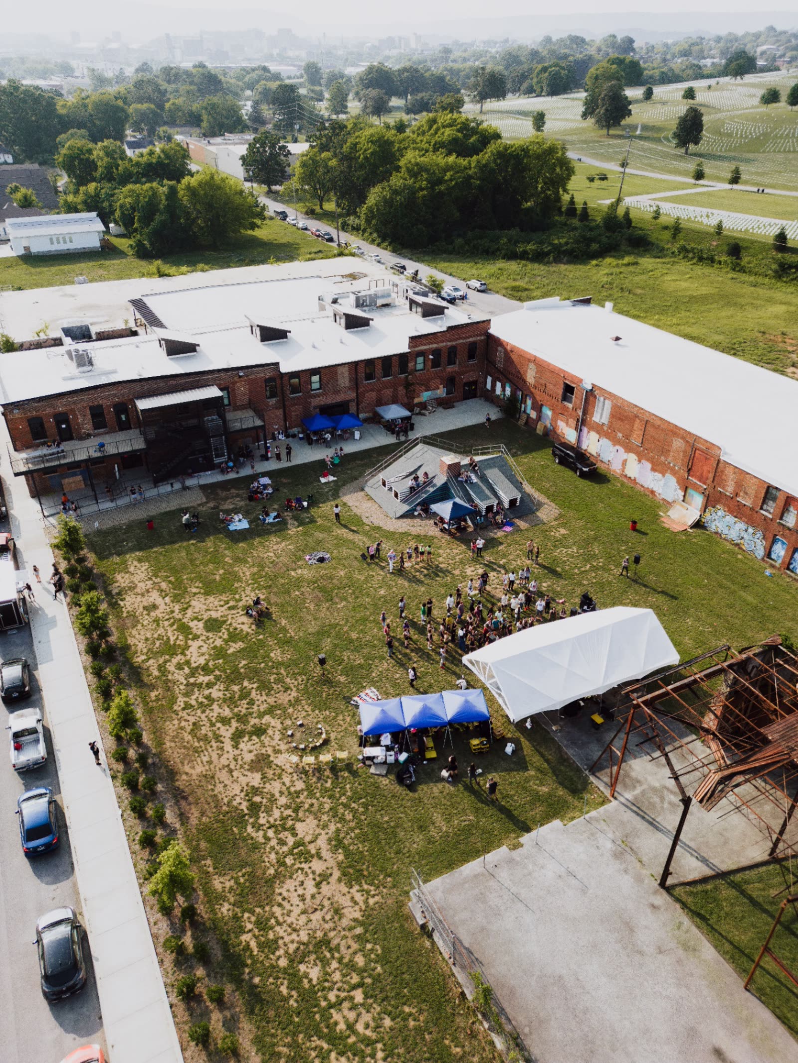 Aerial view of a community gathering with tents in a Texas neighborhood
